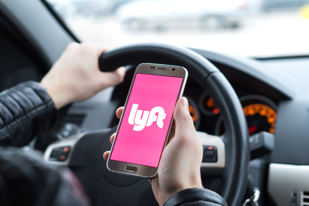 Stylized image of a driver with Lyft logo open on phone