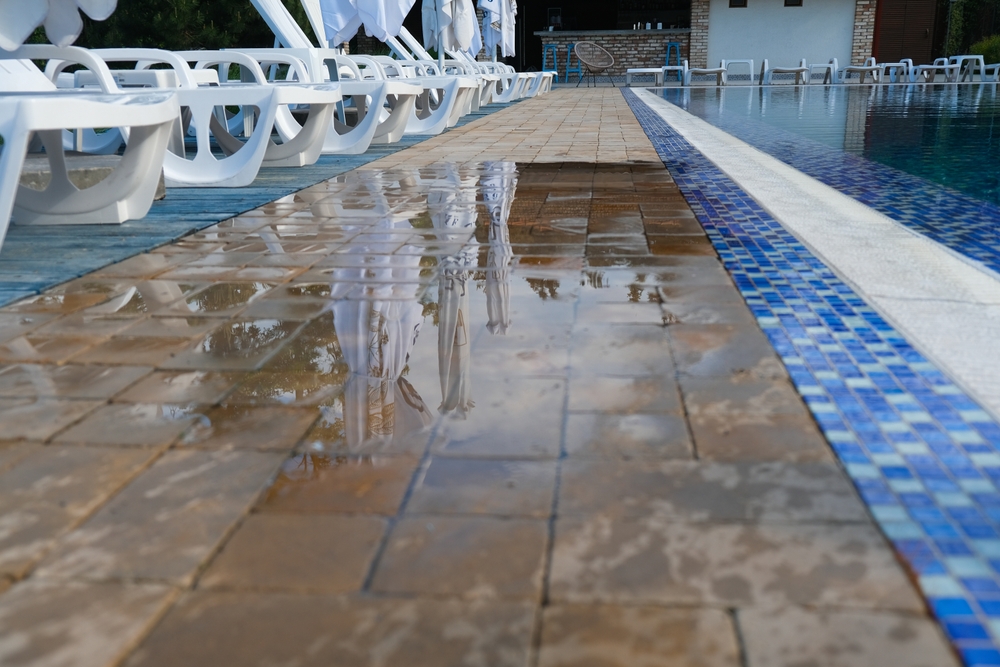 wet walkway next to a swimming pool