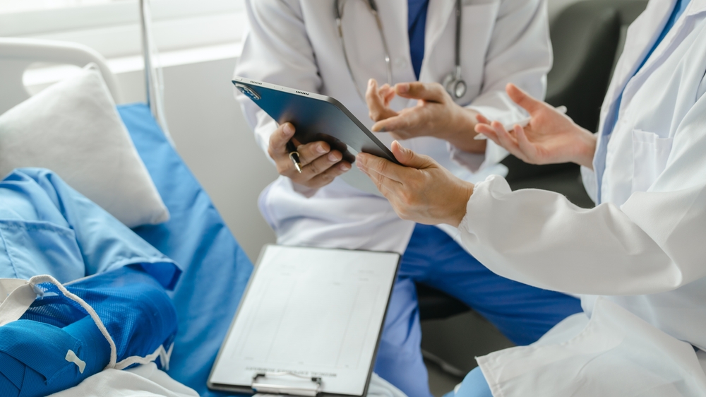 Close-up of doctors speaking to injured patient